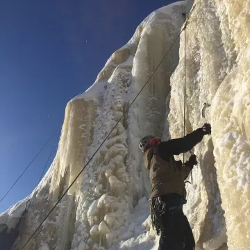 Student climbing frozen waterfall.